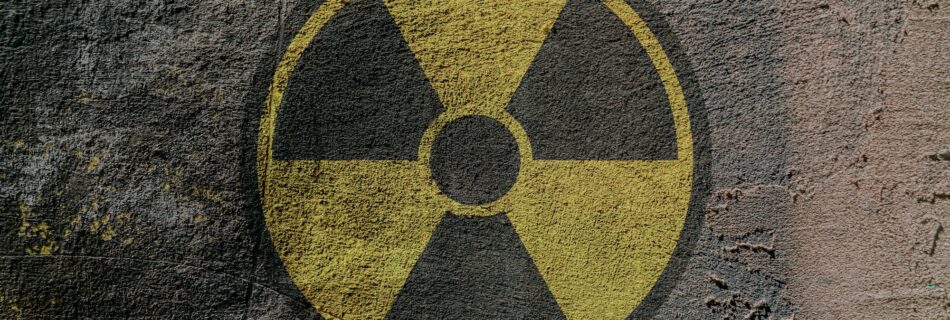 Sign of radioactive danger depicted on a concrete wall